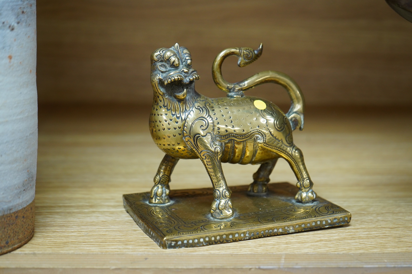 A 19th century south-east Asian brass incense holder in the form of a lion, 12cm wide